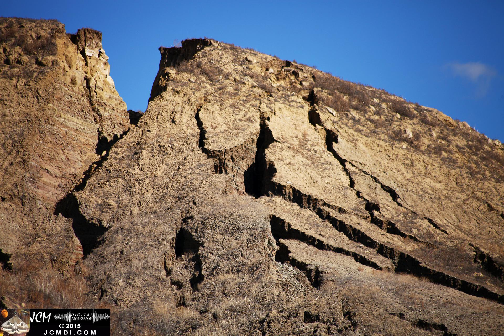 Landslide, buckled pavement, and terrain at Vasquez Canyon Road in Santa Clarita, CA filmed 11-25-2015